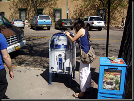 Joanne signs a postcard, while somehow... my arm makes it in a photo from my own camera?!