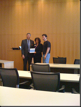 Everyone smiles and honors the plaque